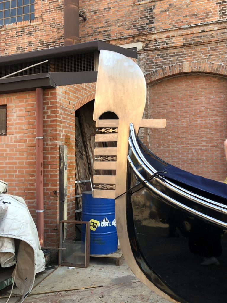 A tail of a gondola with the sections representing the sestiers of Venice